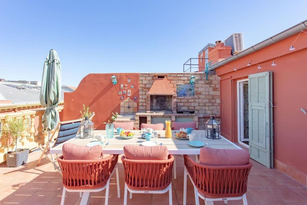 un patio avec une table et des chaises sur un balcon dans l'établissement #48 Suite Jean top floor terrace 5min walk sea AC, à Nice
