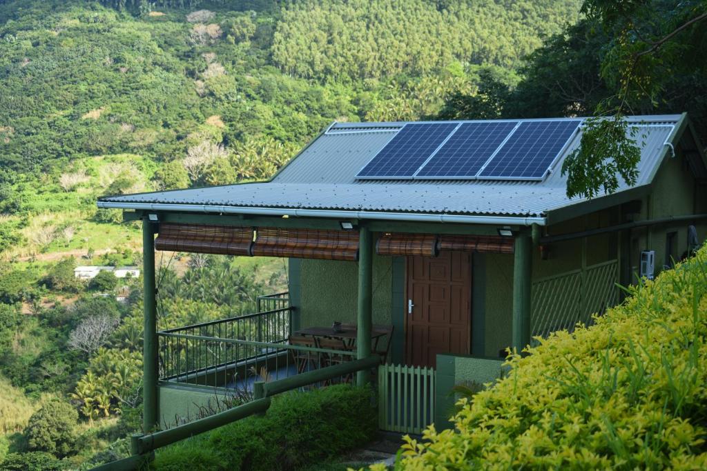 a house with solar panels on the roof at The Green Shack in Quatre Soeurs