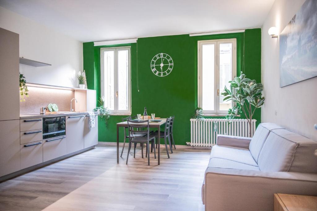 a living room with a green wall and a table at BDC_7 Apartment in Parma