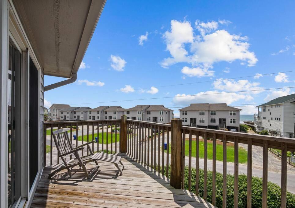 a deck with a bench and a view of condos at Oceanview Townhouse w/ Pool - Newly Renovated in Surf City