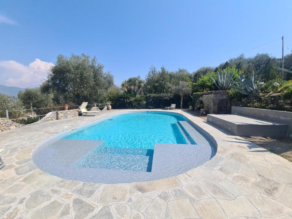 a large swimming pool in a yard with a patio at Villa Draga by PortofinoVacanze in Santa Margherita Ligure