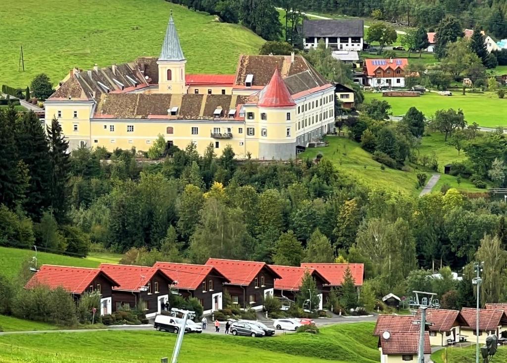 a large building on a hill with red roofs at Ferienpark Gaal in Gaal