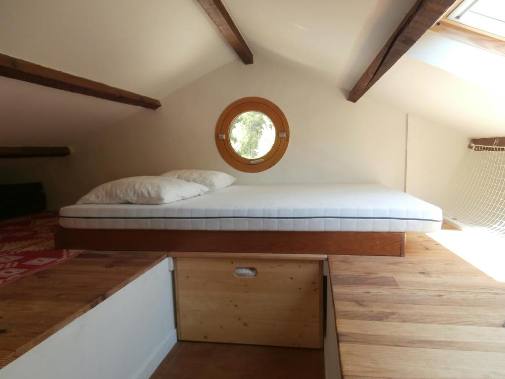 a bed in the middle of a room with a window at Cabanon Calanque Marseille in Le Rove
