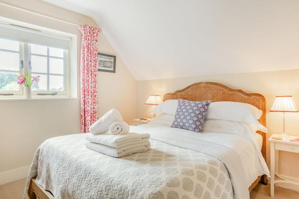 a bedroom with a bed with towels on it at Tiger Inn - Elizabeth in Eastbourne