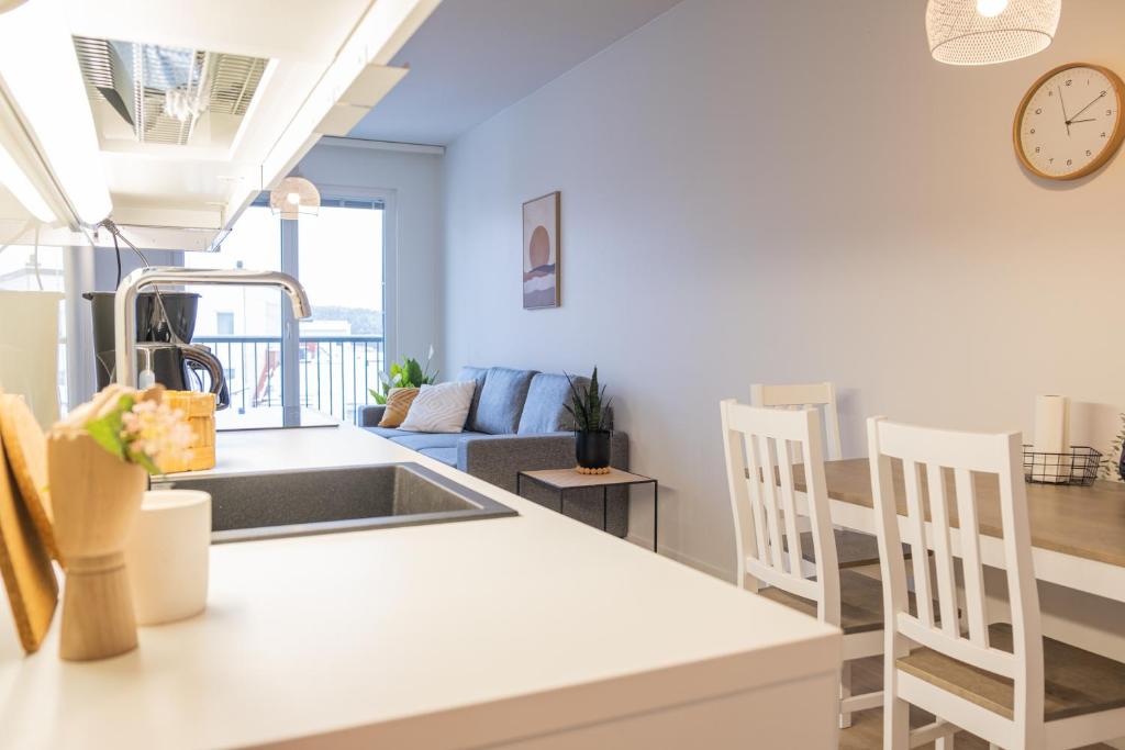 a kitchen and living room with a table and chairs at Snowflake Suites I in Rovaniemi