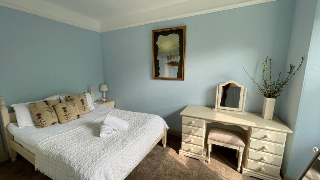 a bedroom with a bed and a table with a mirror at North Middleton Apartment in North Middleton