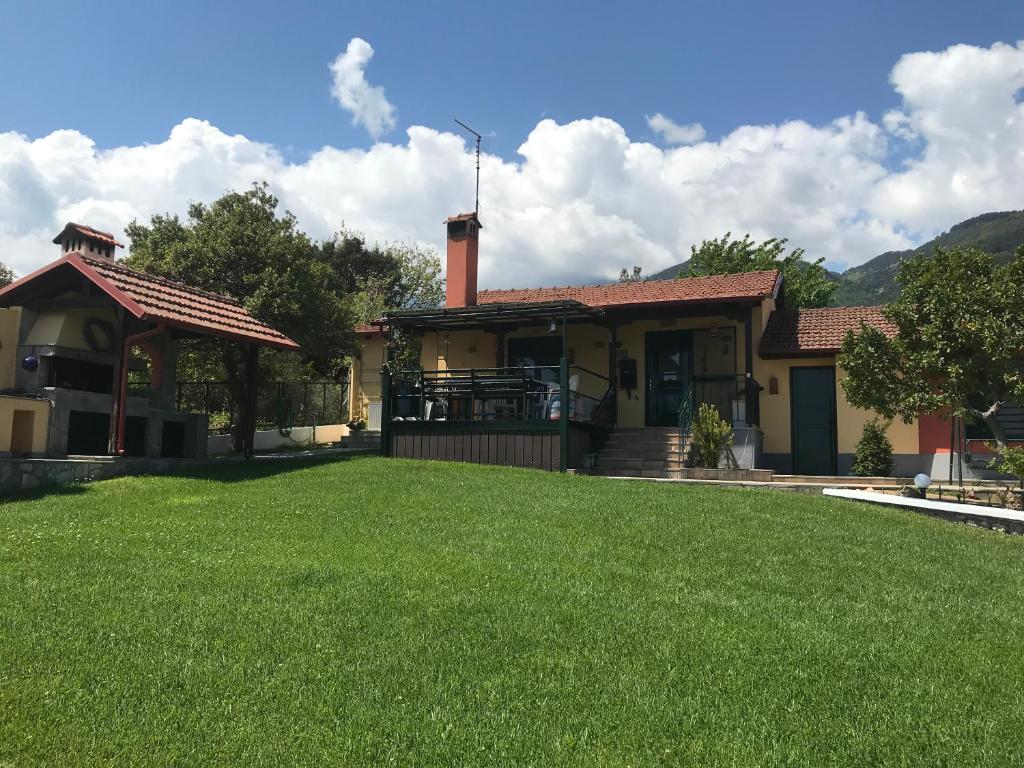a house with a lawn in front of it at PARADISE VILLA in Litochoro