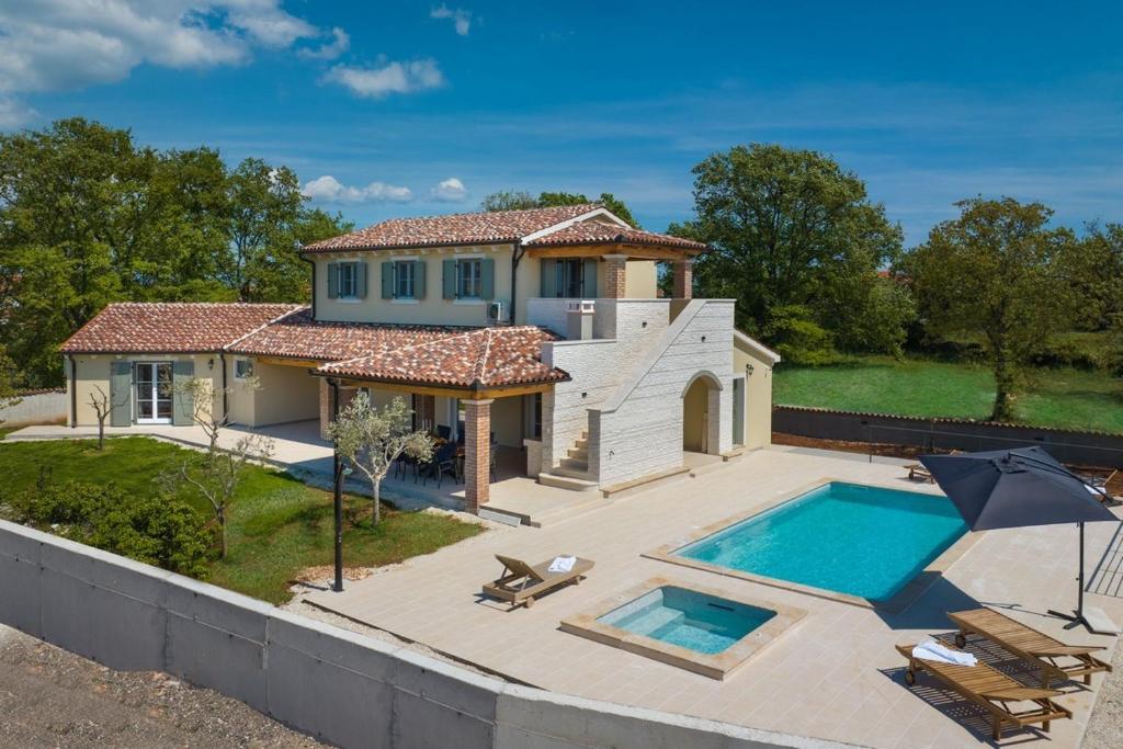 a villa with a swimming pool and a house at Villa Clara in Kavran