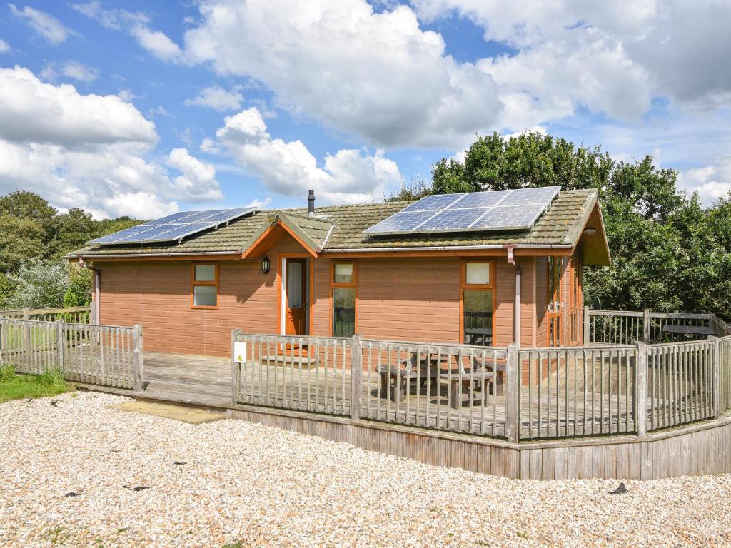 a house with solar panels on the roof at The Hideaway in Bridport