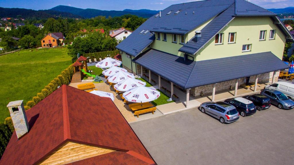 an aerial view of a house with cars parked in a parking lot at Cubus-Beskidy in Bierna