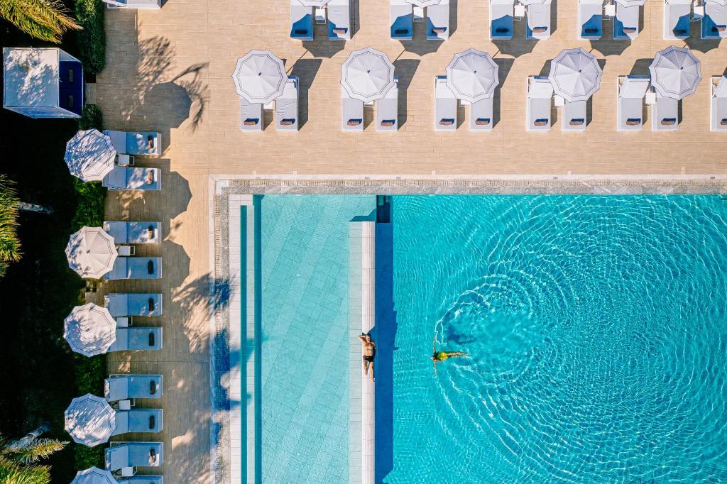 an overhead view of a swimming pool at a hotel at Ivi Mare - Designed for Adults by Louis Hotels in Paphos City