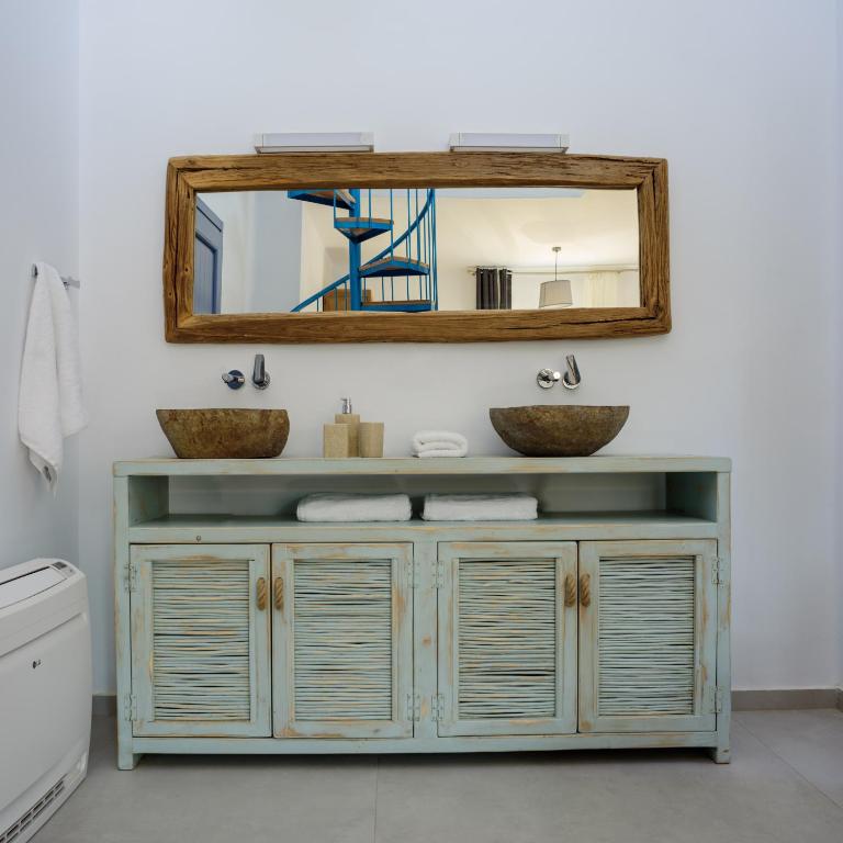 a bathroom with a sink and a mirror at White Dream Suites Antiparos in Antiparos
