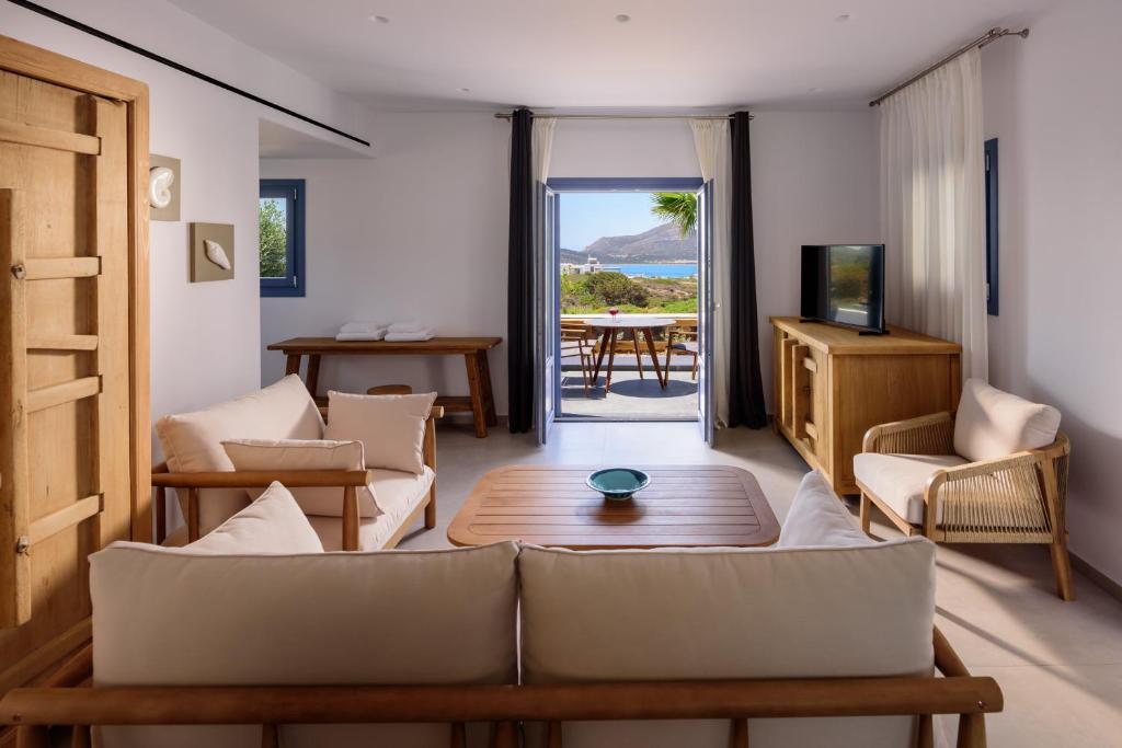 a living room with a couch and a table at White Dream Suites Antiparos in Antiparos