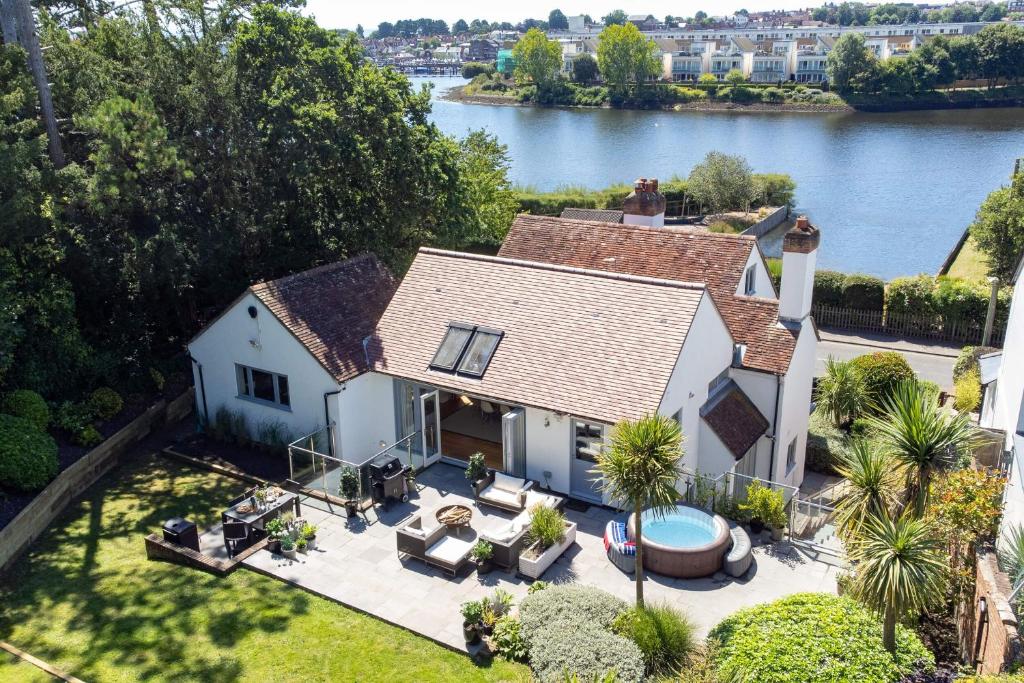 an aerial view of a house with a lake at Harbour View in Lymington