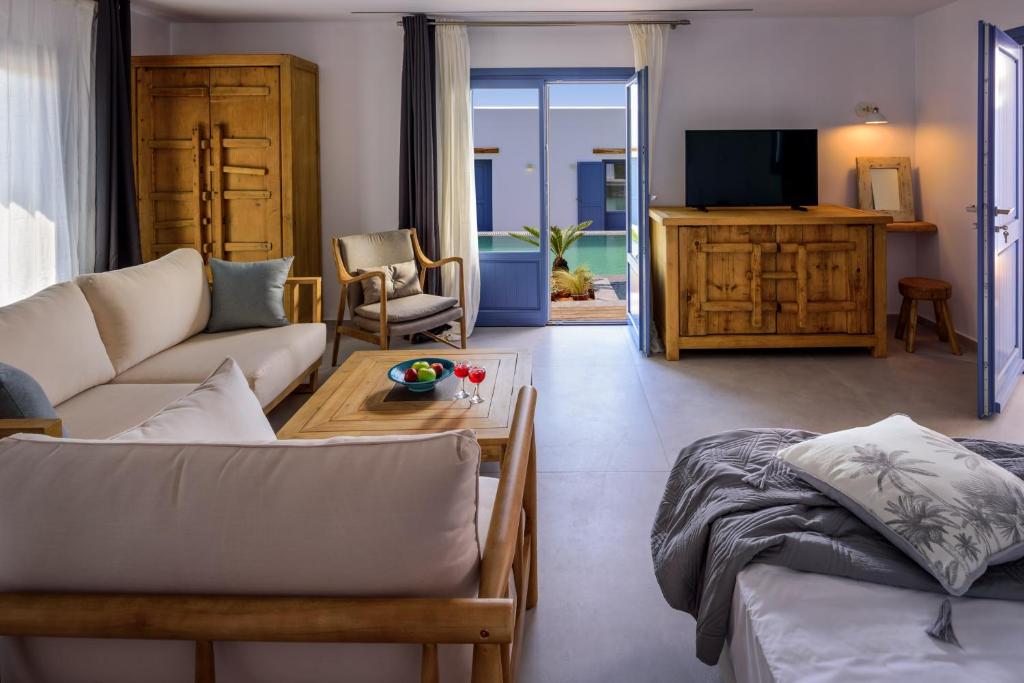 a living room with a couch and a table at White Dream Suites Antiparos in Antiparos