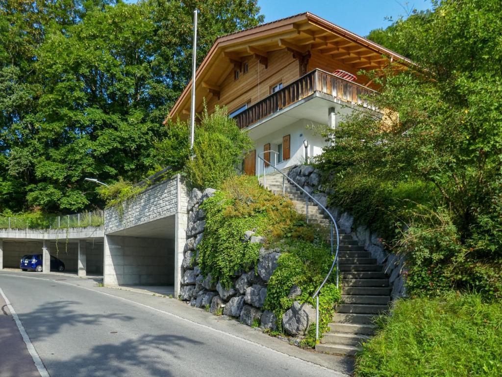 a house on a hill with a garage at Apartment Chalet Holzwurm-1 by Interhome in Grindelwald