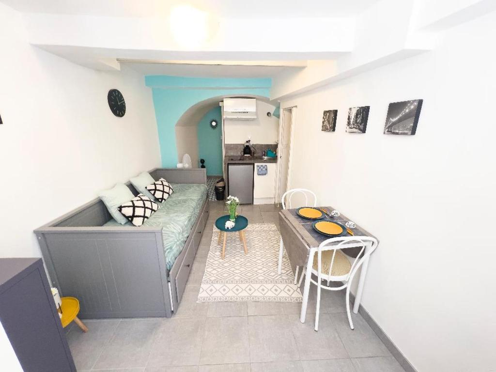 ein Wohnzimmer mit einem Sofa und einem Tisch in der Unterkunft Superbe appartement Montélimar in Montélimar