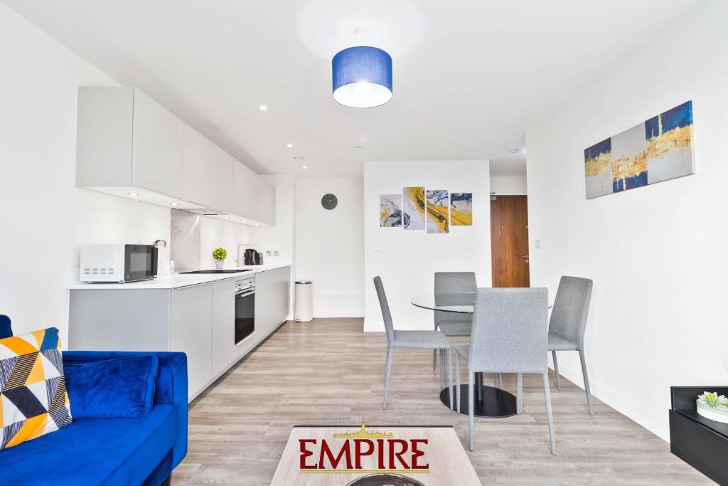 a living room with a blue couch and a table at Lovely One Bedroom Apartment on Broad Street! in Birmingham