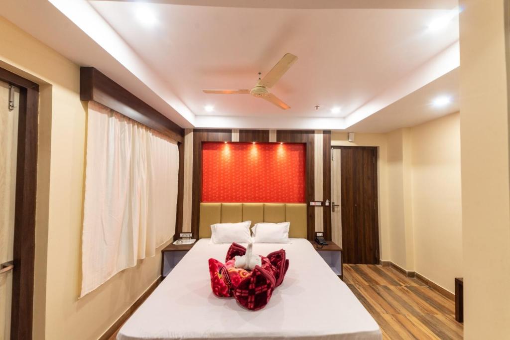 a bedroom with a bed and a ceiling fan at Hotel Signature Near Sea Beach #NewDigha in Digha