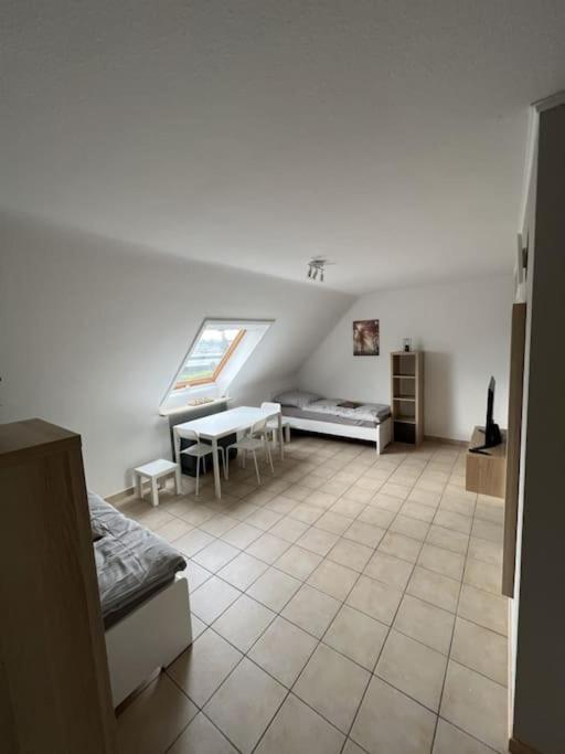a living room with a bed and a table at Große Unterkunft für bis zu 5 Personen MG32 in Mönchengladbach