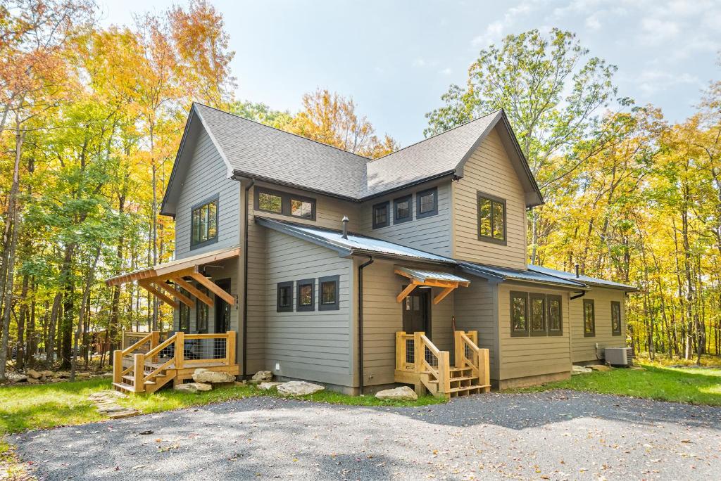 a house in the woods with a driveway at Dreidels Den in McHenry