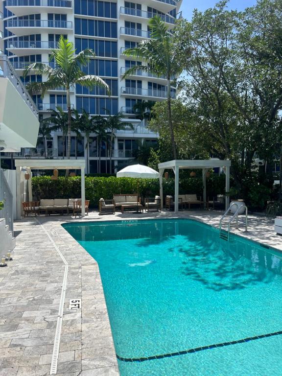 a swimming pool in front of a tall building at Royal Palms Resort & Spa in Fort Lauderdale