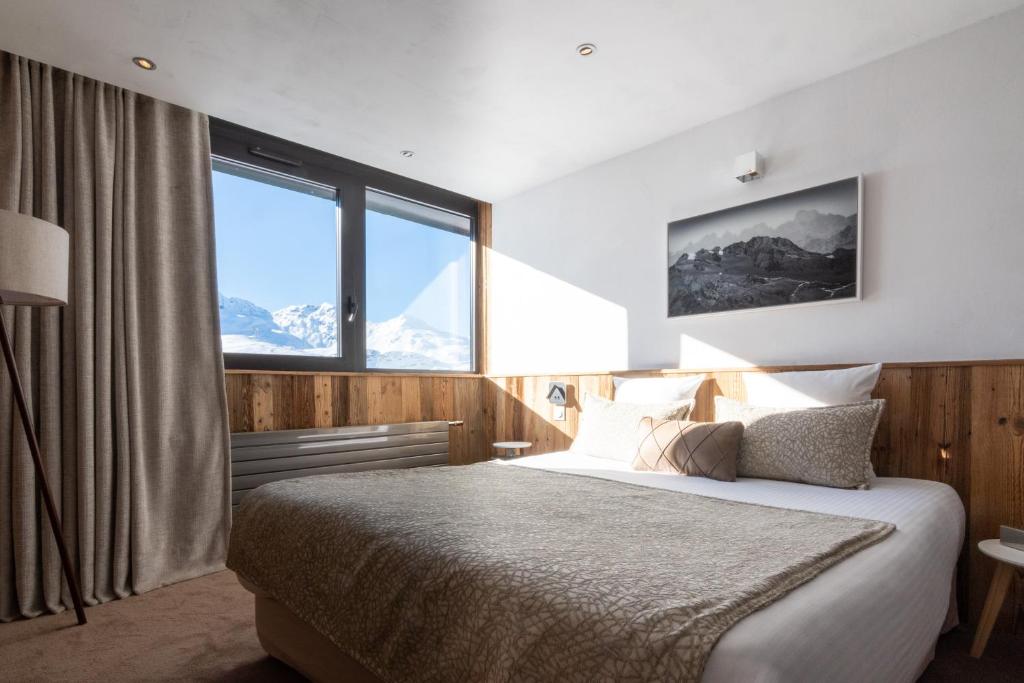 Un ou plusieurs lits dans un hébergement de l'établissement Hotel 3 Vallées Val Thorens