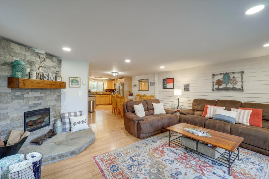 a living room with a couch and a fireplace at Cozy Sugar Mtn Condo with AandC - Walk to Ski and Golf! in Sugar Mountain
