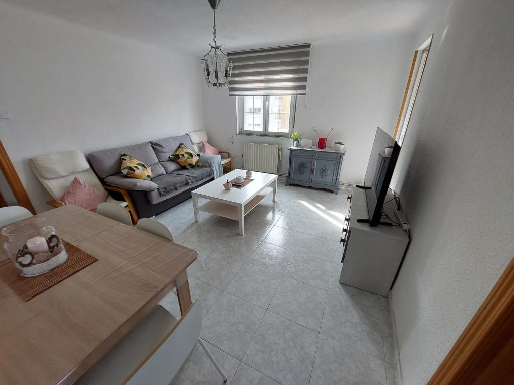 uma sala de estar com um sofá e uma mesa em Alia em Madri