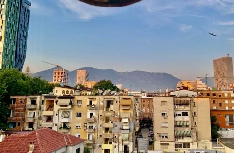 a city with buildings and mountains in the background at CozyFlat in the middle of Tirana in Tirana