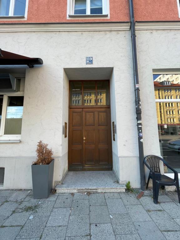 a bench sitting in front of a building with a door at Hause münchen comfort! in Munich