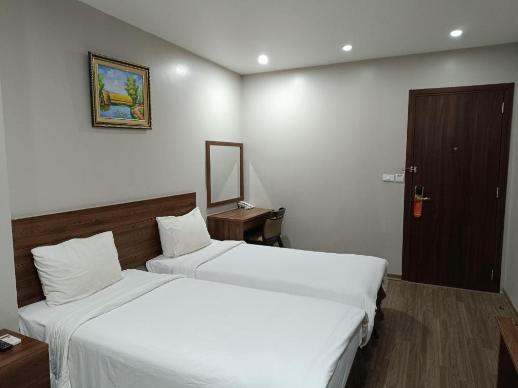 Postel nebo postele na pokoji v ubytování Victor Hanoi Hotel