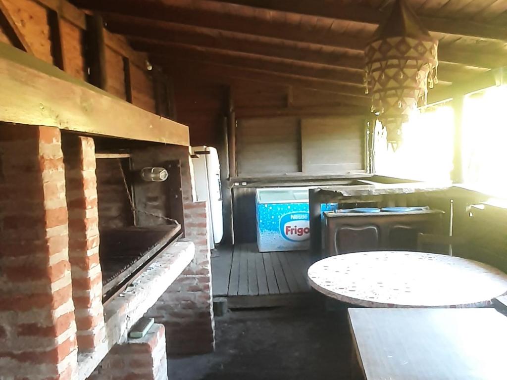 a kitchen with a table and a pizza oven at Flor de Lis apartmento in Mar del Plata