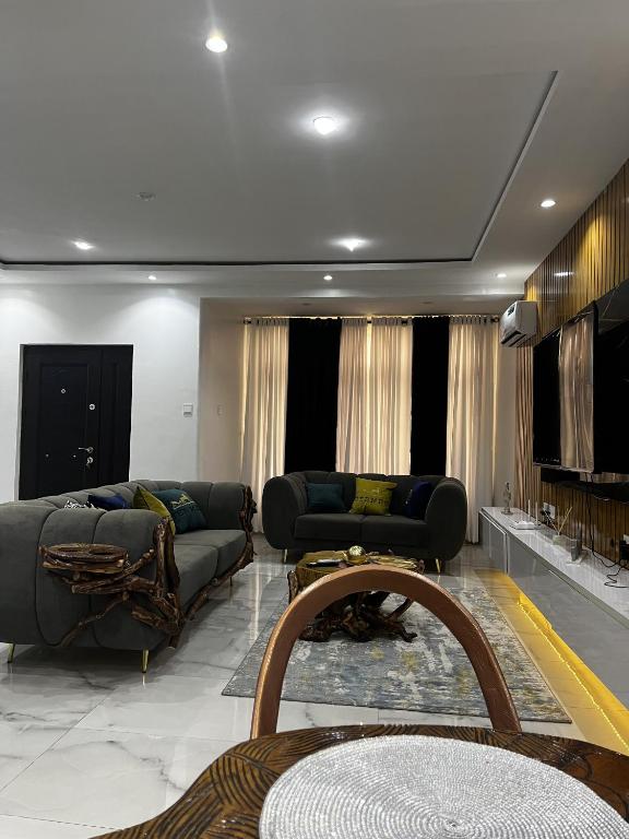 a living room with two couches and a table at Seaview Palace in Lekki