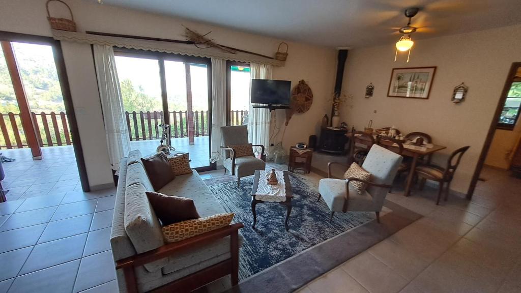 a living room with a couch and chairs and a table at Mountain View 2BR House with Garden & Free Parking Ioannis Ylation Saranti in Nicosia