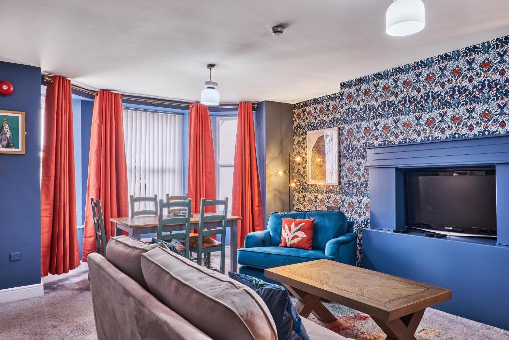 a living room with a couch and a tv at Crawford Square Apartment in Derry Londonderry