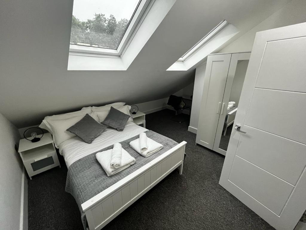 a bedroom with a bed with pillows and a window at 2 bedroom flat in London