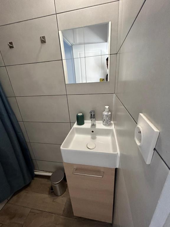 a bathroom with a white sink and a mirror at Cozy home&amp;garden (Paris&#47;Disney) in Noisy-le-Sec