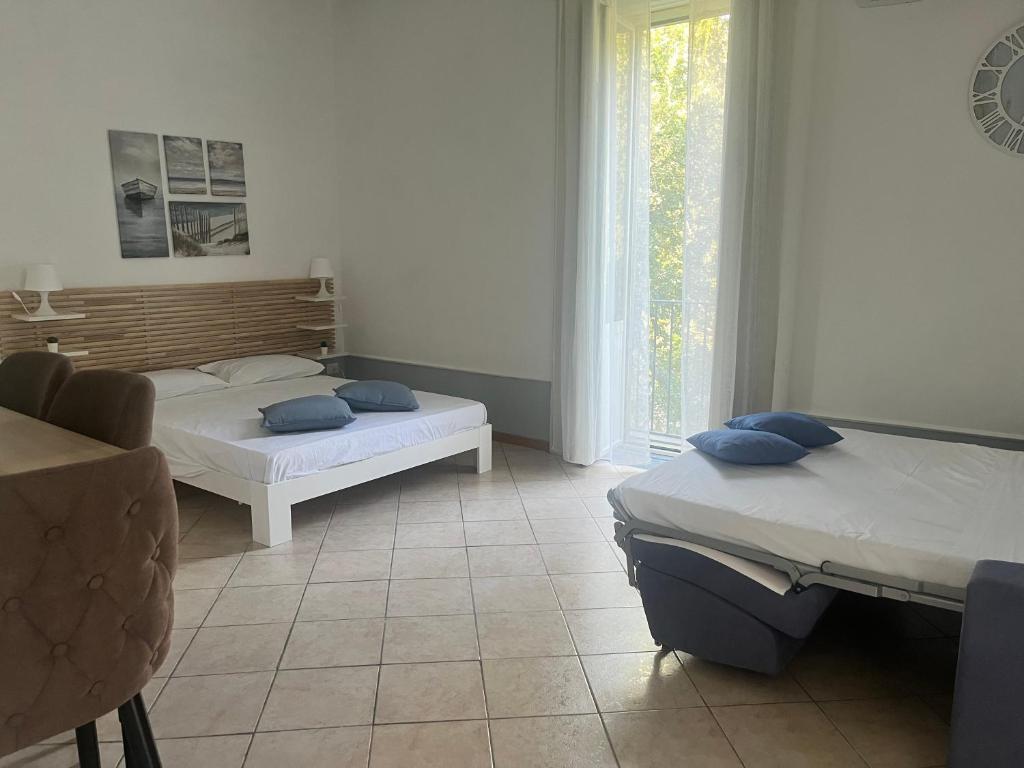 a bedroom with two beds and a window at Mediterraneo Apartment in Ercolano