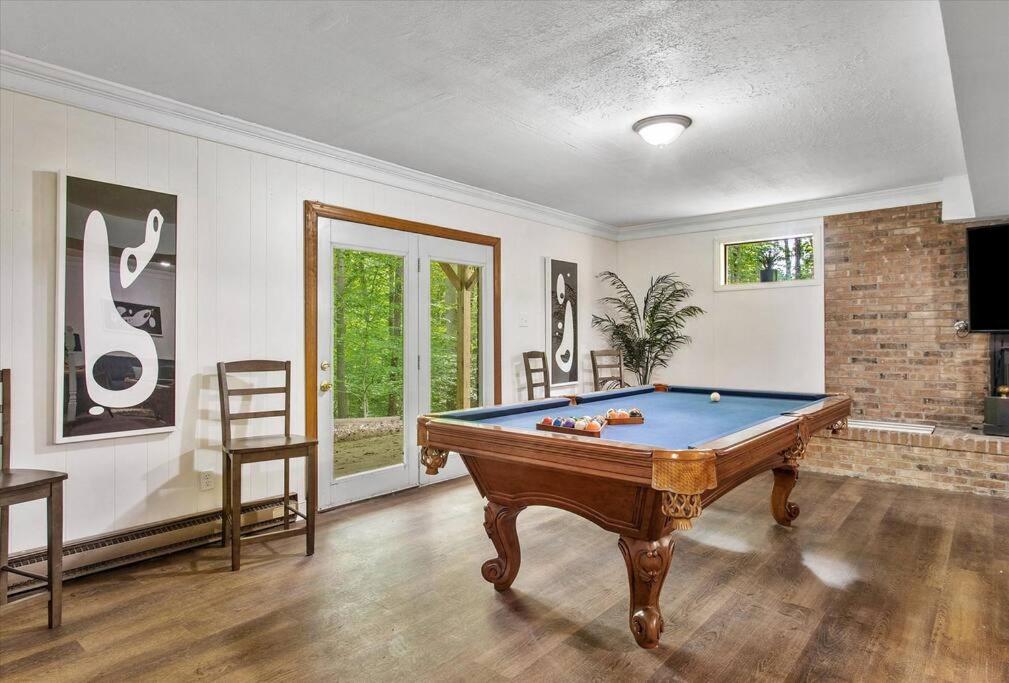 a living room with a pool table in it at Serenity in the Suburbs: Your Gorgeous RVA Getaway in Richmond