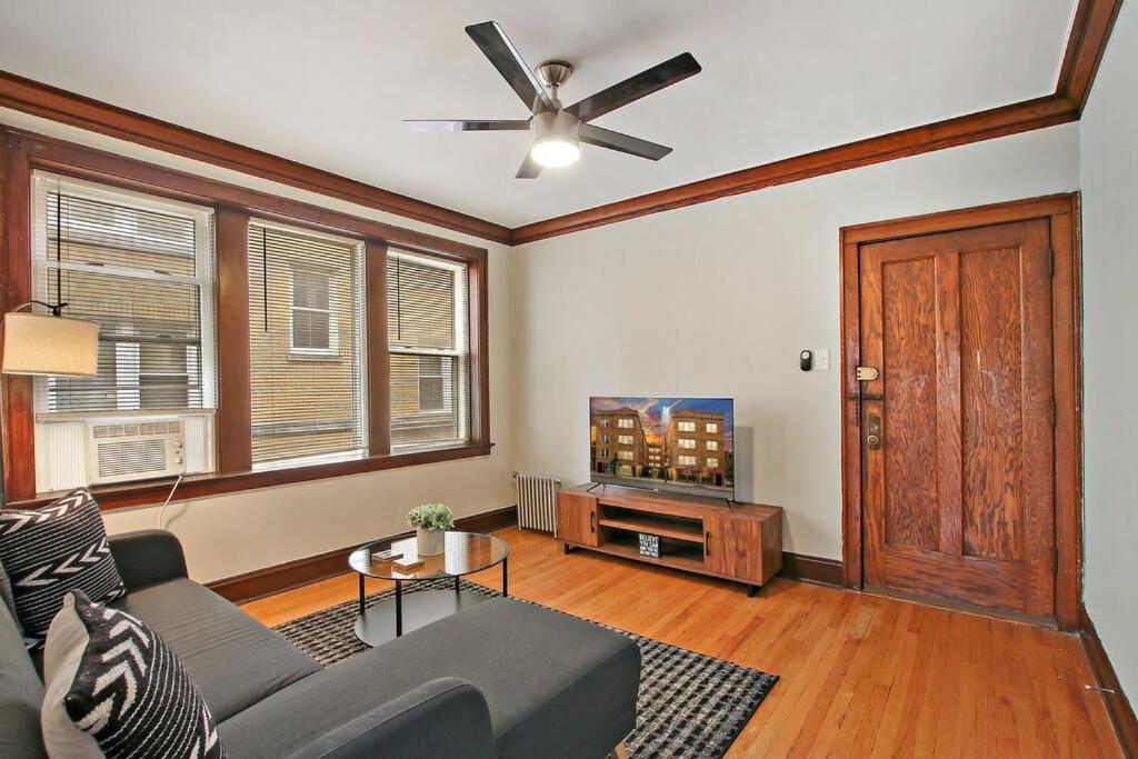 a living room with a couch and a tv at Warm & Inviting 2BR Apartment - Fullerton 1B in Chicago