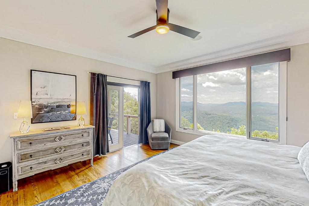 a bedroom with a bed and a large window at Jump Off Rock Retreat in Hendersonville