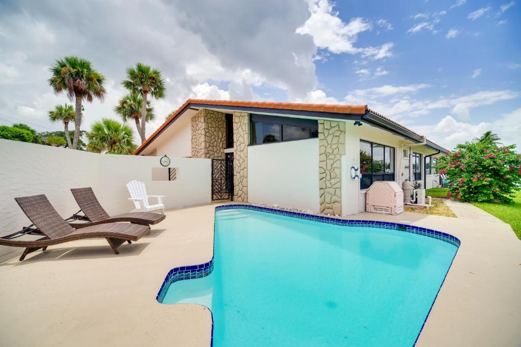 a swimming pool in front of a house at Cocoa Beach House on Banana River Walk to Ocean! in Cocoa Beach