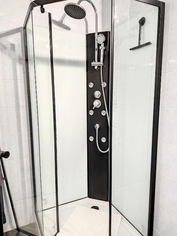 a shower with a glass door in a bathroom at Bluepart 4 personnes in Chalons en Champagne