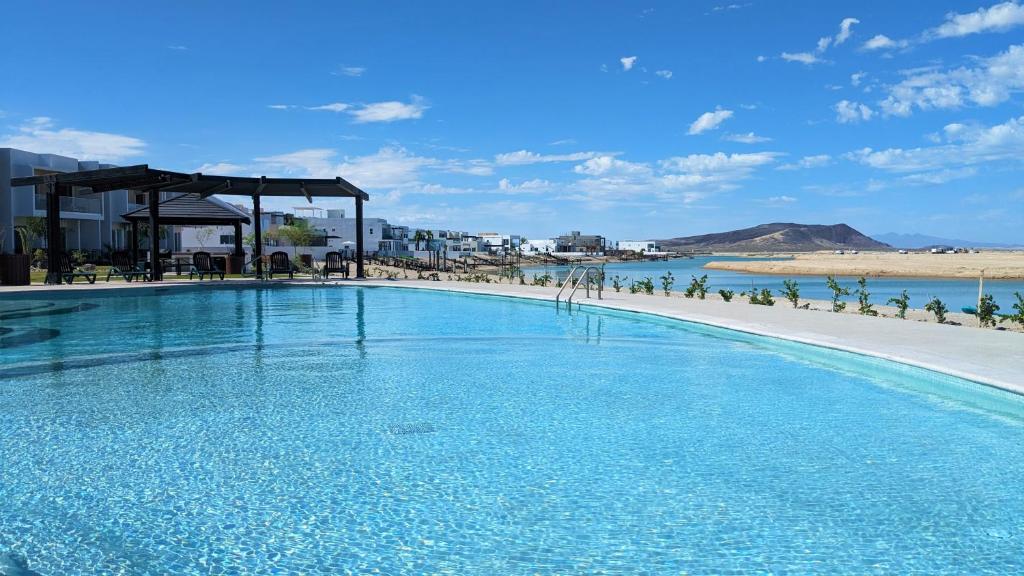 a large swimming pool with a beach in the background at Islas Del Mar, Eagle Village B9 in Puerto Peñasco