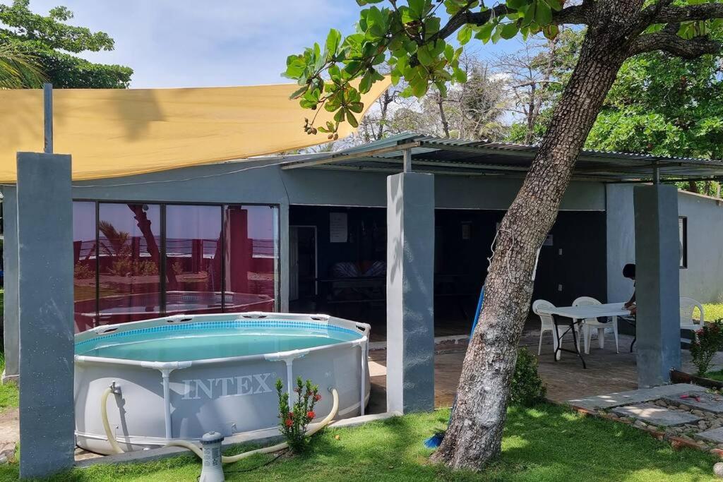 a house with a hot tub in a yard at Hermosa Casa de Playa DejaBlue SV (con Mini Golf) in La Libertad