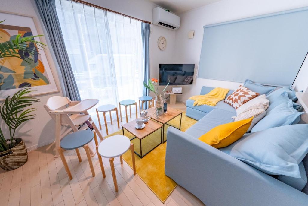 a living room with a blue couch and a table at HOTEL Flag Tokyo - Vacation STAY 29759v in Tokyo