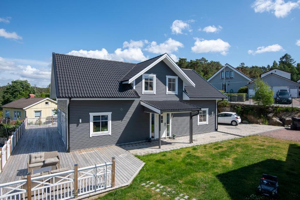 a house with a deck and a yard at The Rose Valley room in a shared villa in Gothenburg