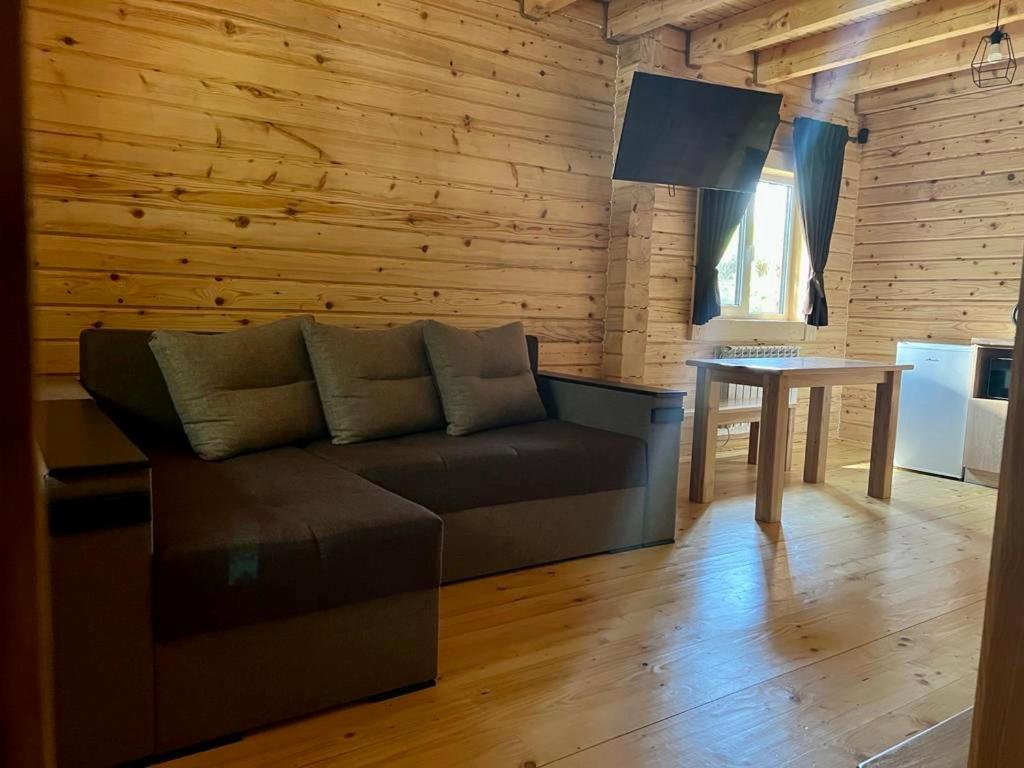 a living room with a couch and a table at Family Resort in Mostiska