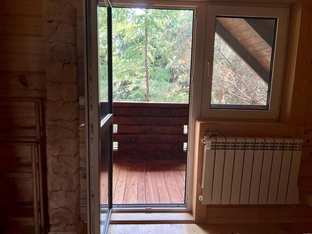 an open door to a porch with a window at Family Resort in Mostiska